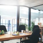 AI Agent Jumps The Fence Modern conference room with wooden table and black chairs