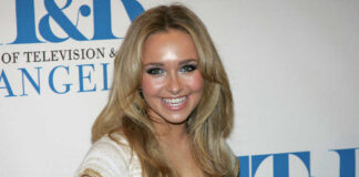 Smiling woman with long blonde hair at a media event