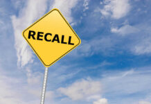 RECALL: Dangerous Shards Found in Breakfast Food Yellow sign with RECALL text against blue sky.