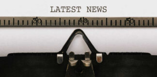 Close-up of a typewriter with a sheet of paper displaying the words 'LATEST NEWS'