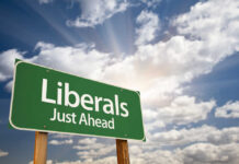 Lib Governor Torches Popular Product Green roadside sign against a cloudy sky