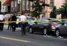 Platform Fight Ends in One Shot Police and crime scene tape on city street.