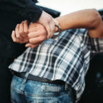 Pre-Dawn Raid SHOCKS America Person in handcuffs arrested by police officer.