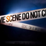 Chilling Horror: Toddler Stabbed Police tape reading 'CRIME SCENE DO NOT CROSS' in a dark setting