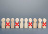 Tech Giant Wants Workers OUT Wooden human figures in a row with red X marks on some