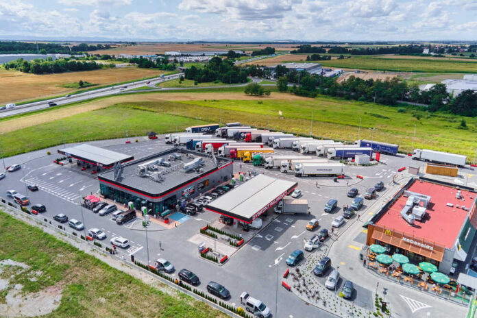Trucks,On,Parking,Near,Gas,Station,,Shop,Store,And,Mc Subway restaurant inside a grocery store.