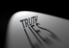 SHOCKER: FBI Testimony Under Fire Truth casting shadow spelling Lies on curved surface.