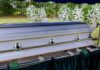 Televangelist Empire Falls – Now He’s Gone A casket at a graveside surrounded by floral arrangements