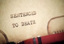 UPDATE: Botched Execution Chaos Close-up of a typewritten document stating 'SENTENCED TO DEATH'