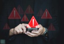 Discord Cult Orders End In Death Person using smartphone with warning icons overlay