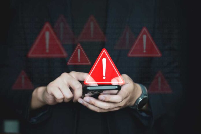 Person using smartphone with warning icons overlay