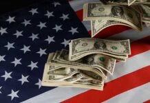 Dollar bills arranged on an American flag