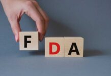 Tainted Shots? FDA Steps In A hand holding a wooden block with the letter F, next to blocks spelling FDA