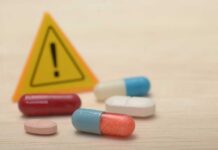 CHAOS: HHS Quietly Unlocks Drugs Pills with warning sign in background