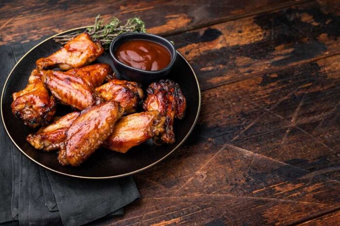 Deliciously,Sticky,Teriyakis,Sauce,Chicken,Wings,,Bursting,With,Flavor,,Perfect Chicken wings with barbecue sauce on a black plate