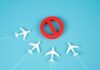 Chaos Turns Nation Into No-Fly Trap A red prohibition sign surrounded by white airplane models on a blue background