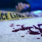 DETAILS: Fashion Power Duo Found Dead Blood on pavement with police tape and a hand in the background