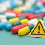 Capsules and a yellow warning sign