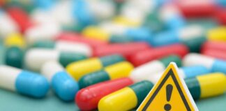 Capsules and a yellow warning sign