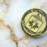 CIA File Hints At Mind-Hacking CIA emblem coin on marble surface