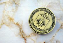 CIA File Hints At Mind-Hacking CIA emblem coin on marble surface