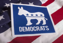 Democratic Party donkey logo on American flag background.