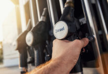 Red Diesel Goes Legal – What’s The Catch? A hand holding a diesel fuel nozzle at a gas station
