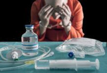 Blurred hospital room with multiple patients and nurses